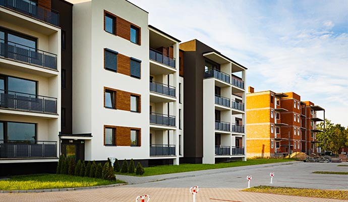 An exterior view of a modern multi-story residential apartment complex