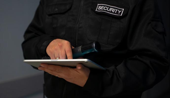 Close-up of a security professional interacting with a tablet