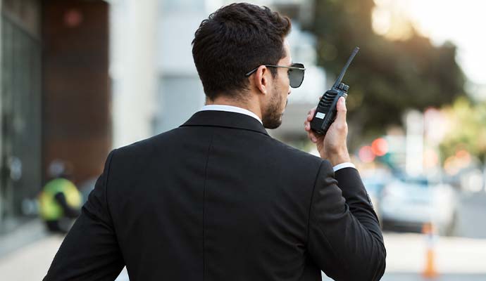Professional security guard using walkie talkie