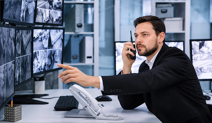 Security consultant monitoring camera feeds