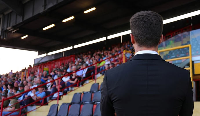 Security guard monitoring a stadium crowd