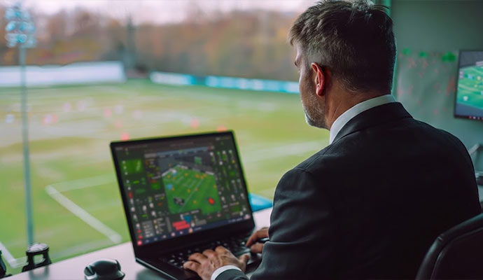 Security guard monitoring a stadium from a control room
