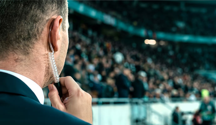 Security guard with earpiece at a stadium