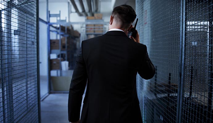 Security officer using radio in secure storage area