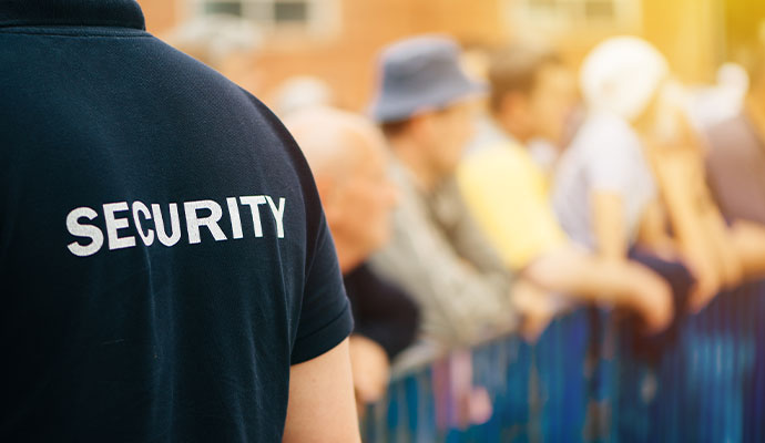 Event security guard monitoring crowd at barrier
