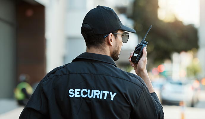 Professional security guard using walkie talkie