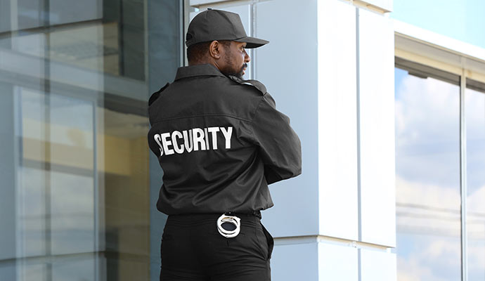 Security guard standing outside modern office building