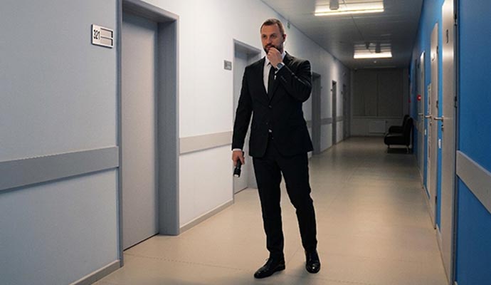 Security guard with a flashlight patrolling in a medical facility