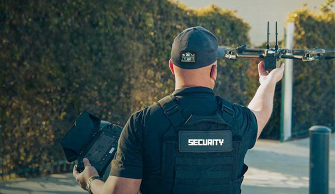 Security officer controlling drone