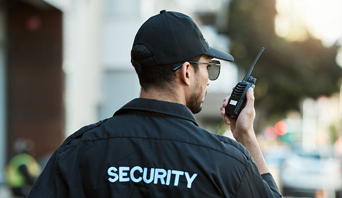Security person communicating through walkie talkie