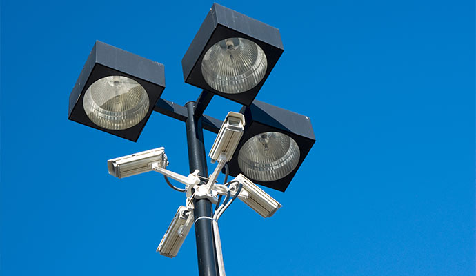 Security pole with floodlights and surveillance cameras