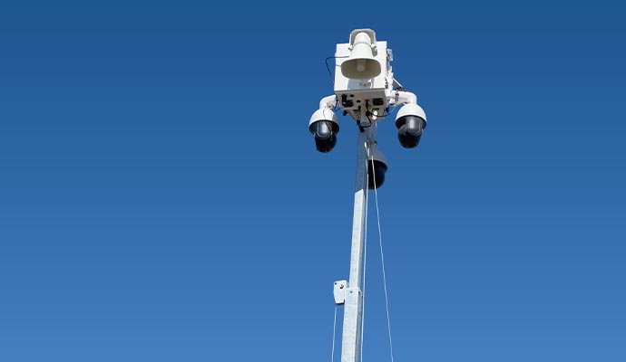 Surveillance pole with cameras and loudspeaker