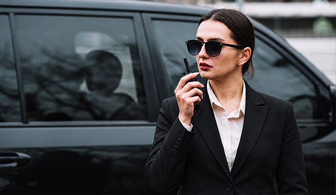 Professional security officer with radio providing subcontracted security service